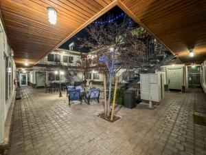 a patio with a table and chairs and a tree at Modern condo near Fremont Street in Las Vegas
