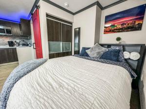 a bedroom with a large bed with a red door at Modern condo near Fremont Street in Las Vegas