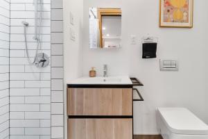 a bathroom with a sink and a toilet at Beautiful Lofts in Downtown Montreal in Montréal +81 photos