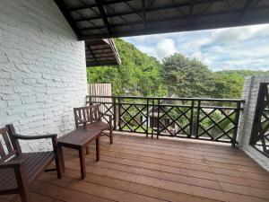 two benches sitting on a deck with a view at Ao Prao Resort in Ko Samed