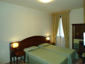 Posteľ alebo postele v izbe v ubytovaní Hotel Belvedere