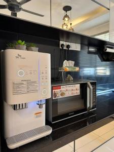 a microwave oven on a counter in a kitchen at Stylaa Homestay Bertam in Kepala Batas