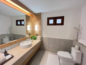 a bathroom with a toilet and a sink and a mirror at Ao Prao Resort in Ko Samed