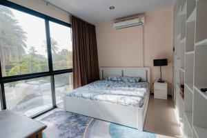 a bedroom with a bed and a large window at Lux apartments TOP in Koh Samui