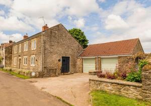 an old stone house with a garage at Gorgeous Rural 4 Bed Farm Cottage - With Hot Tub! in Norton Saint Philip