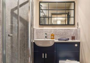 a bathroom with a sink and a mirror at Gorgeous Rural 4 Bed Farm Cottage - With Hot Tub! in Norton Saint Philip +96 photos