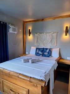 Un dormitorio con una cama grande con almohadas azules. en Mountain view house with AC El Nido corong corong, en El Nido