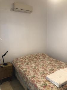 a bedroom with a bed and a air conditioner at El Solaz en la Ciudad in San Juan +4 photos