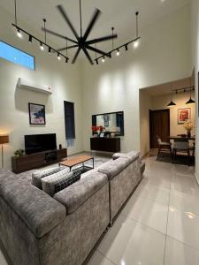 a large living room with a couch and a table at Stylaa Homestay Kedah in Kampong Guar Nanas
