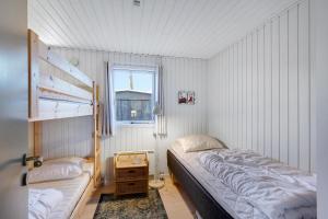 a small bedroom with a bed and a window at Super Cozy And Child-Friendly House Close To The Water in Knebel