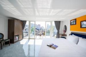 a hotel room with a bed with two books on it at Dream Premium Hotel & Spa in Hanoi +78 photos