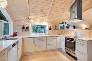 a kitchen with white appliances and a wooden ceiling at Stunning Home In Rønde With 3 Bedrooms And Wifi in Rønde