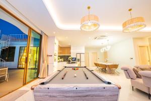a living room with a pool table at Paco Villa Pattaya in Jomtien Beach