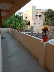 una pared de hormigón con macetas. en Sri arunachala shiva homestay 2, en Tiruvannāmalai