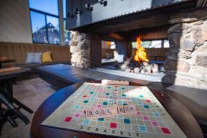 a game on a table in front of a fireplace at Outbound Mammoth in Mammoth Lakes