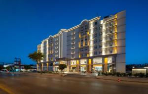 ein großes Gebäude in einer Stadtstraße bei Nacht in der Unterkunft Radisson Hotel Mersin in Mersin
