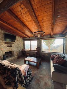 a living room with a couch and a table at Cozy view Arachova in Arachova