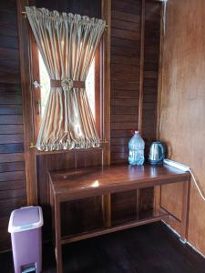 Cette chambre dispose d'une fenêtre avec un banc en bois. dans l'établissement Charitas cottage, à Nuhu Tawun