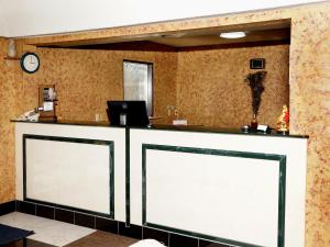 a counter with two white doors in a room at Executive Inn Opp in Opp