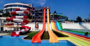 a water park with a water slide in front of a building at Cozy Flat With Sea View in Tangier