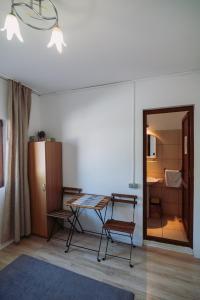 a room with a table and a chair and a bedroom at AlmaVille Mamaia in Mamaia Sat/Năvodari