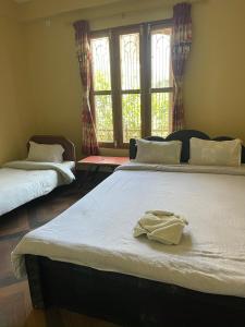 Rúm í herbergi á Tara guesthouse - Sauraha,Chitwan
