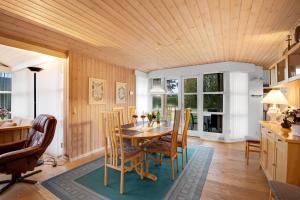 a dining room with a table and chairs at Cozy House In Grenaa, Close To A Lovely Sandy Beach in Grenå +12 photos