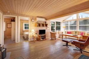 a large living room with a wooden ceiling at Cozy House In Grenaa, Close To A Lovely Sandy Beach in Grenå