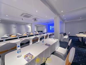 a conference room with white tables and chairs at Zuri Place Hotel Limited in Oyugis