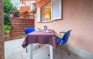 a table with blue chairs and a purple table cloth at Lovely Apartment In Banjole With Wifi in Banjole +13 photos