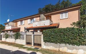a house with a fence in front of it at Lovely Apartment In Banjole With Wifi in Banjole