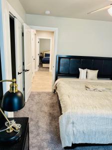 a bedroom with a bed and a table with a lamp at A place like nowhere else in Lawton