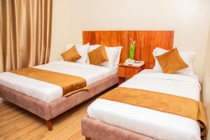 Postel nebo postele na pokoji v ubytování Flamarc Hotel