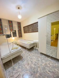 a hospital room with two beds and a shower at Хостел Особнячок in Bishkek