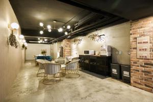 a room with a table and chairs and a kitchen at York Hotel in Taipei
