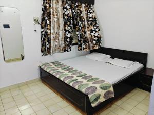 a small bed in a room with a window at Kiara Home stays in Varanasi