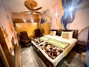 a bedroom with two beds and a ceiling fan at Jhelum One Hotel, Shandar Chowk in Jhelum