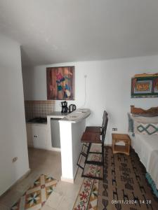 a bedroom with a bed and a desk in a room at Studio Traditionnel a louer-Mahdia in Mahdia +13 photos
