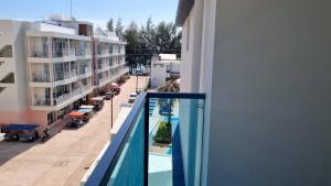 a balcony of a building with a swimming pool at Grandblue condominium 405,406 in Ban Tha Fat