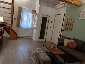 a living room with a couch and a table at Casa MARGHERITA in Grumes
