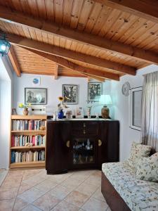 a living room with a couch and a book shelf at Villasabella in Laganas
