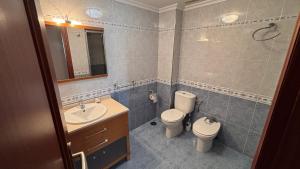 a bathroom with a toilet and a sink at Casa Frijol 20metres from the beach in Los Alcázares