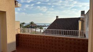a balcony with a view of the ocean at Casa Frijol 20metres from the beach in Los Alcázares