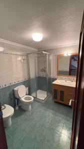 a bathroom with a toilet and a shower and a sink at Casa Frijol 20metres from the beach in Los Alcázares