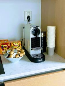 a coffee maker on a counter with a bowl of bread at SEAVIEW 2 SINGLE BEDS LUXURY CENTRAL STATION- Oslo in Oslo