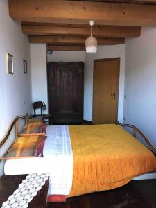a bedroom with a large bed in a room at Casa Vacanze Emily nel parco del Monte Cucco in Casalvento