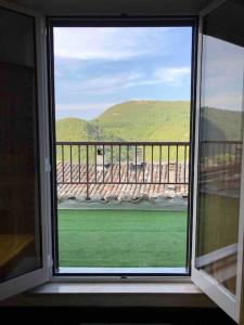 a window in a room with a view of a mountain at Casa Vacanze Emily nel parco del Monte Cucco in Casalvento +28 photos