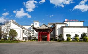 a building with a red structure in front of it at Hilton Garden Inn Dali Ancient City in Dali