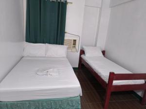 Voodi või voodid majutusasutuse V Star CALAPAN - HOURLY! DAILY! WEEKLY! MONTHLY! BAGO! MALINIS! MAY PARKING! toas