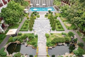 an overhead view of a garden with a swimming pool at Senna Hue Hotel in Hue